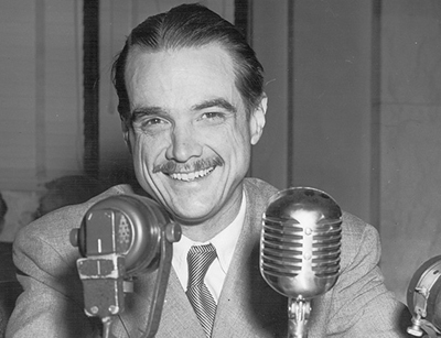 Howard Hughes with a broad smile and obviously enjoying the proceedings.